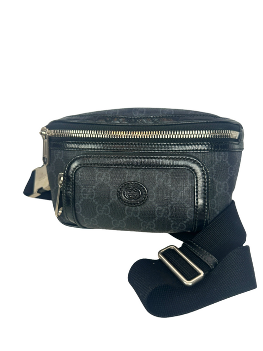 Black patterned waist bag with a strap on a white background